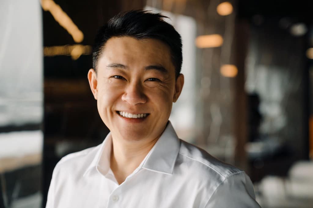 Man smiling after receiving dental care